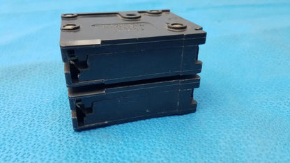Stack of three black plastic eaton br220 2-pole 20 amp circuit breaker units for reuse medical equipment safety