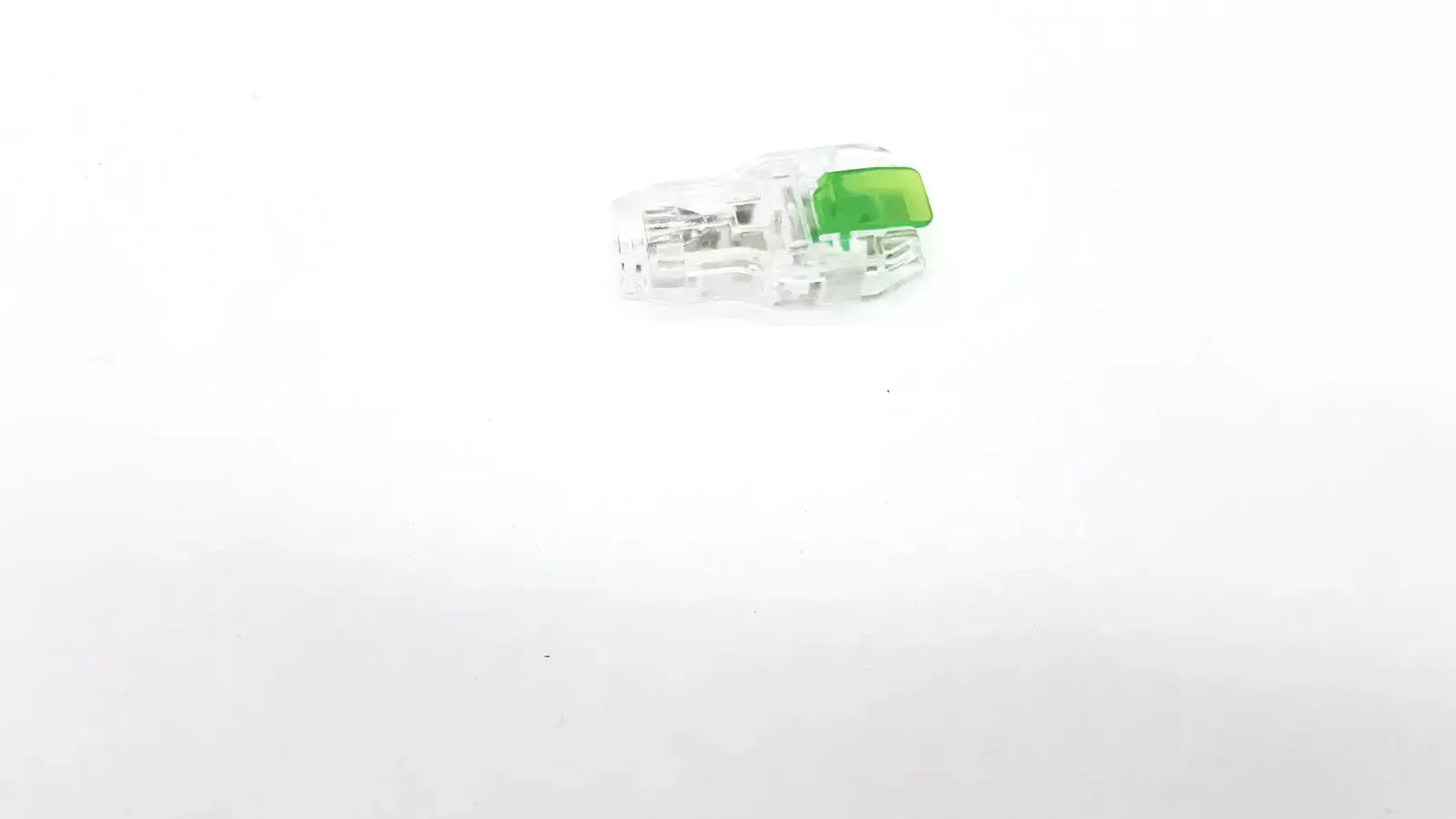 Clear plastic ecg adapter clip with bright green rectangular component for medical connection use