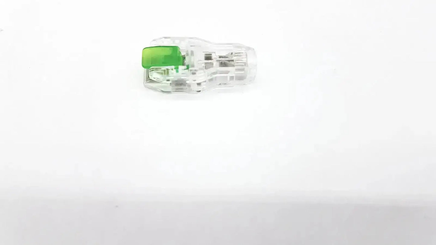 Clear plastic ecg adapter clip 2056813-014 rev a with bright green push-button mechanism for secure connections