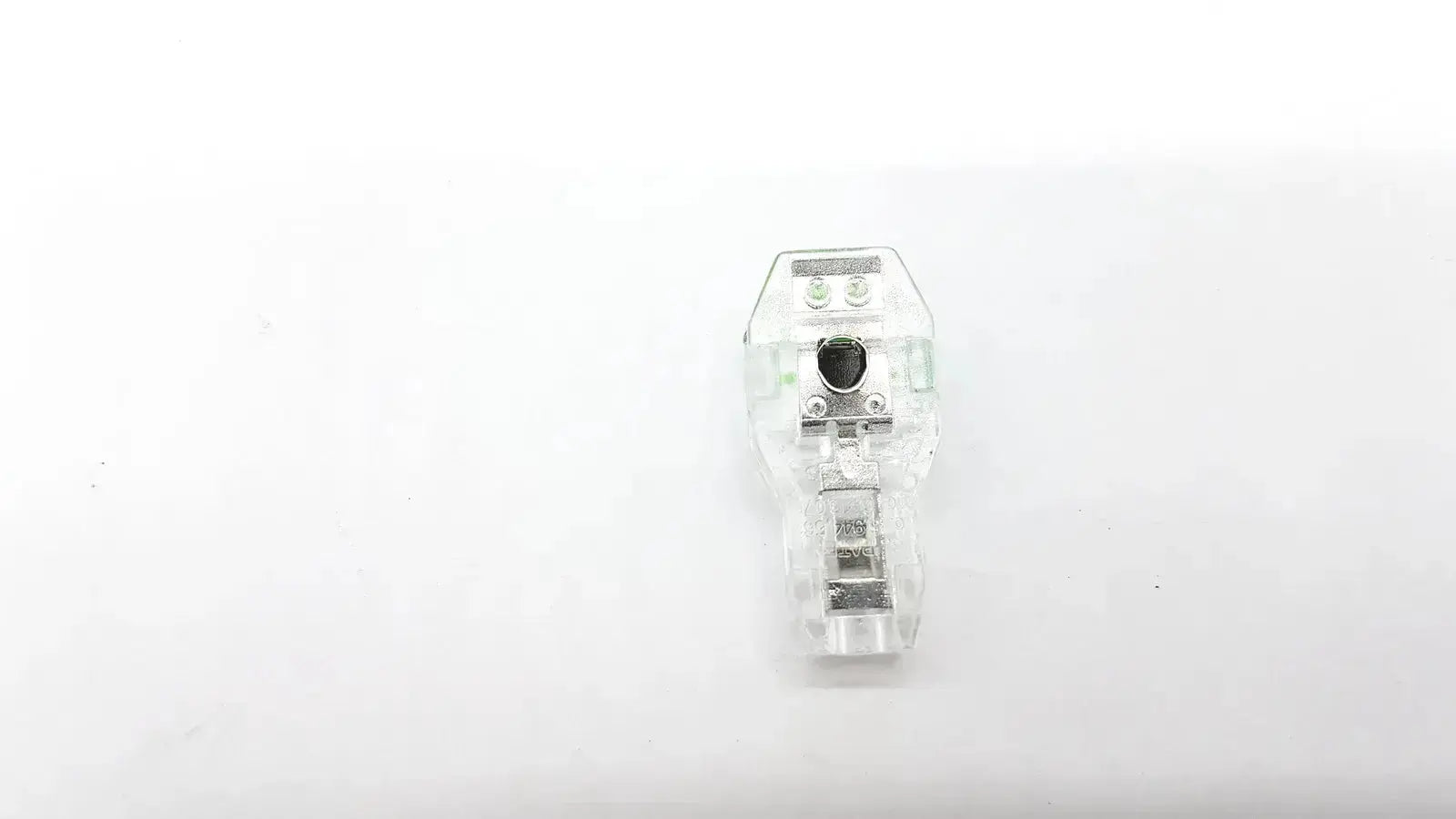 Clear plastic ecg adapter clip 2056813-014 rev a with metallic terminals and central black component for secure connection