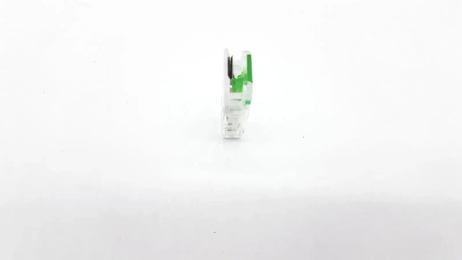 White and green plastic ecg adapter clip with black internal components for medical electrocardiogram use