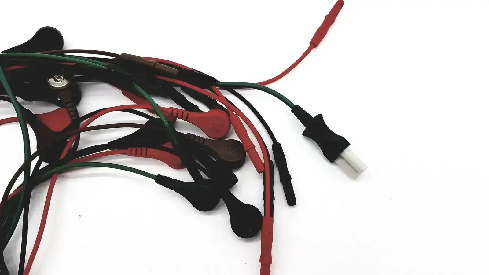 A bundle of ecg bedside monitor snap cables with red and green insulated wires and black plastic connectors for medical use