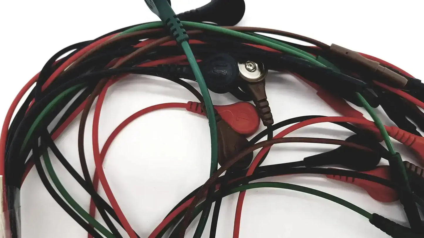 A tangle of red green and black snap cables with plastic connectors for ecg bedside monitor use