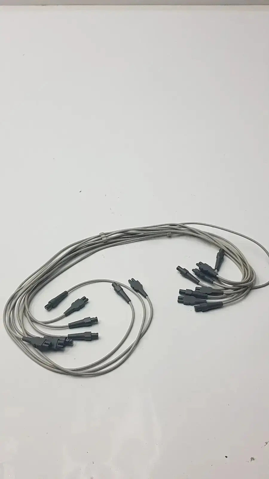 Gray fiber optic ecg leadwire set cable with multiple black connector ends for universal vital signs diagnostics