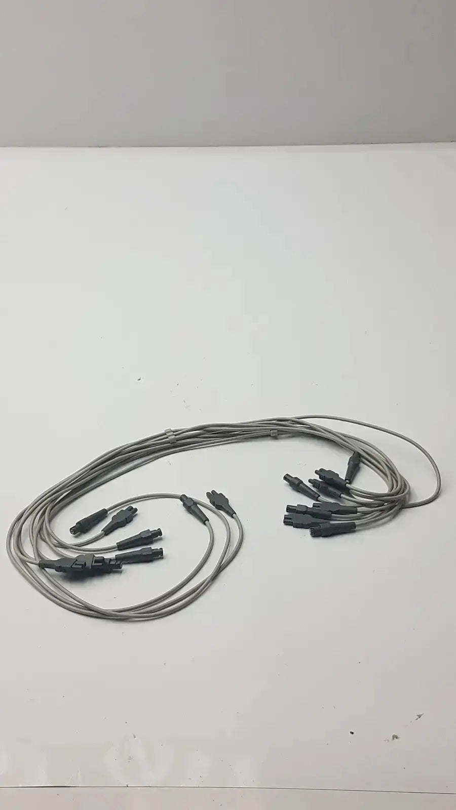 Gray fiber optic ecg leadwire set cable with multiple black connector ends for vital signs diagnostic cardiology use