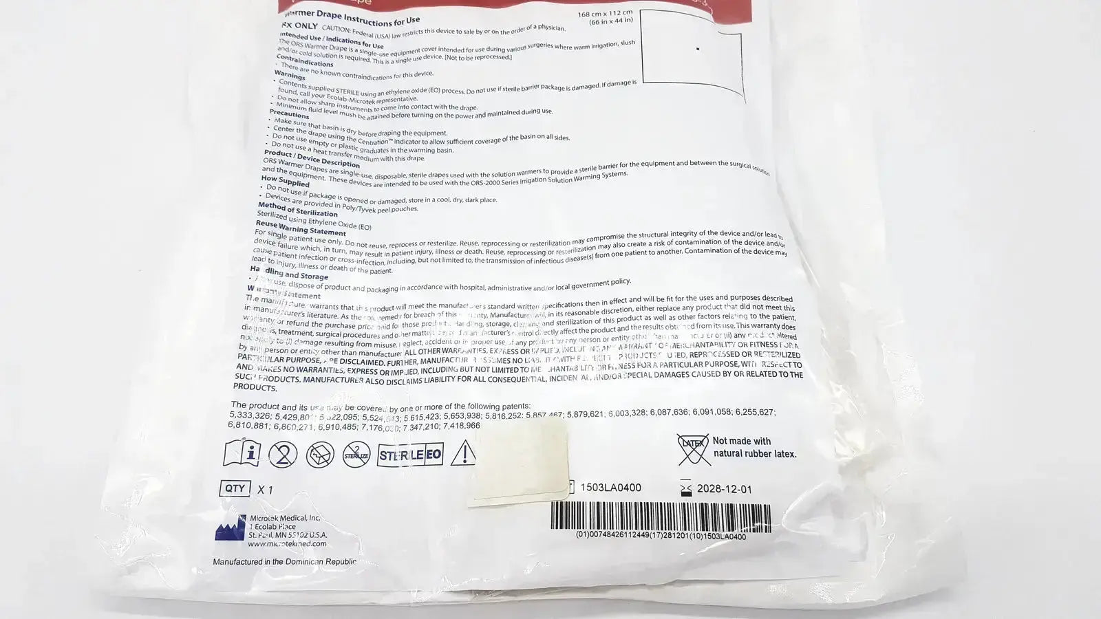White paper label with black text on the back of ecolab ors-300 warmer drape exp showing instructions and barcode