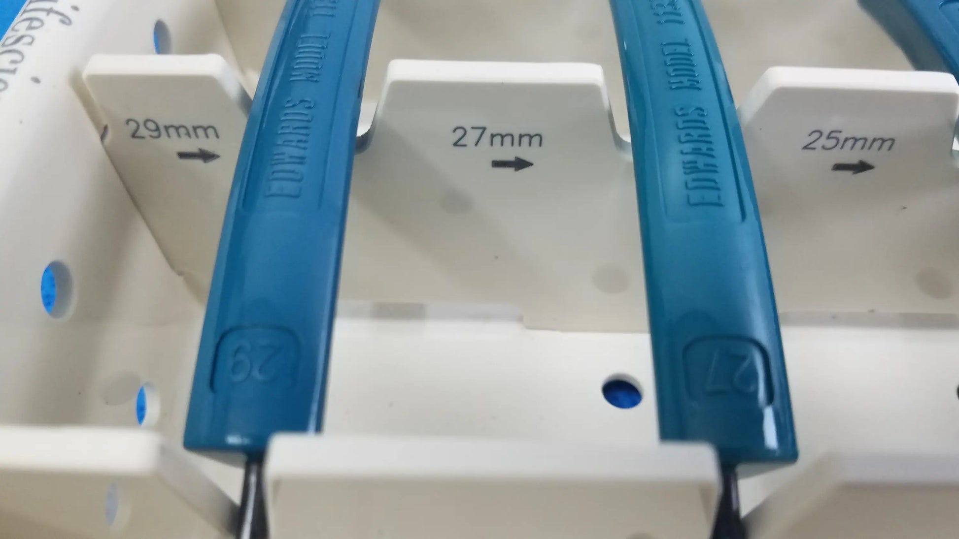 Blue plastic electrical circuit breakers with engraved size markings in edwards life science aortic valve sizer set for buy used medical equipment