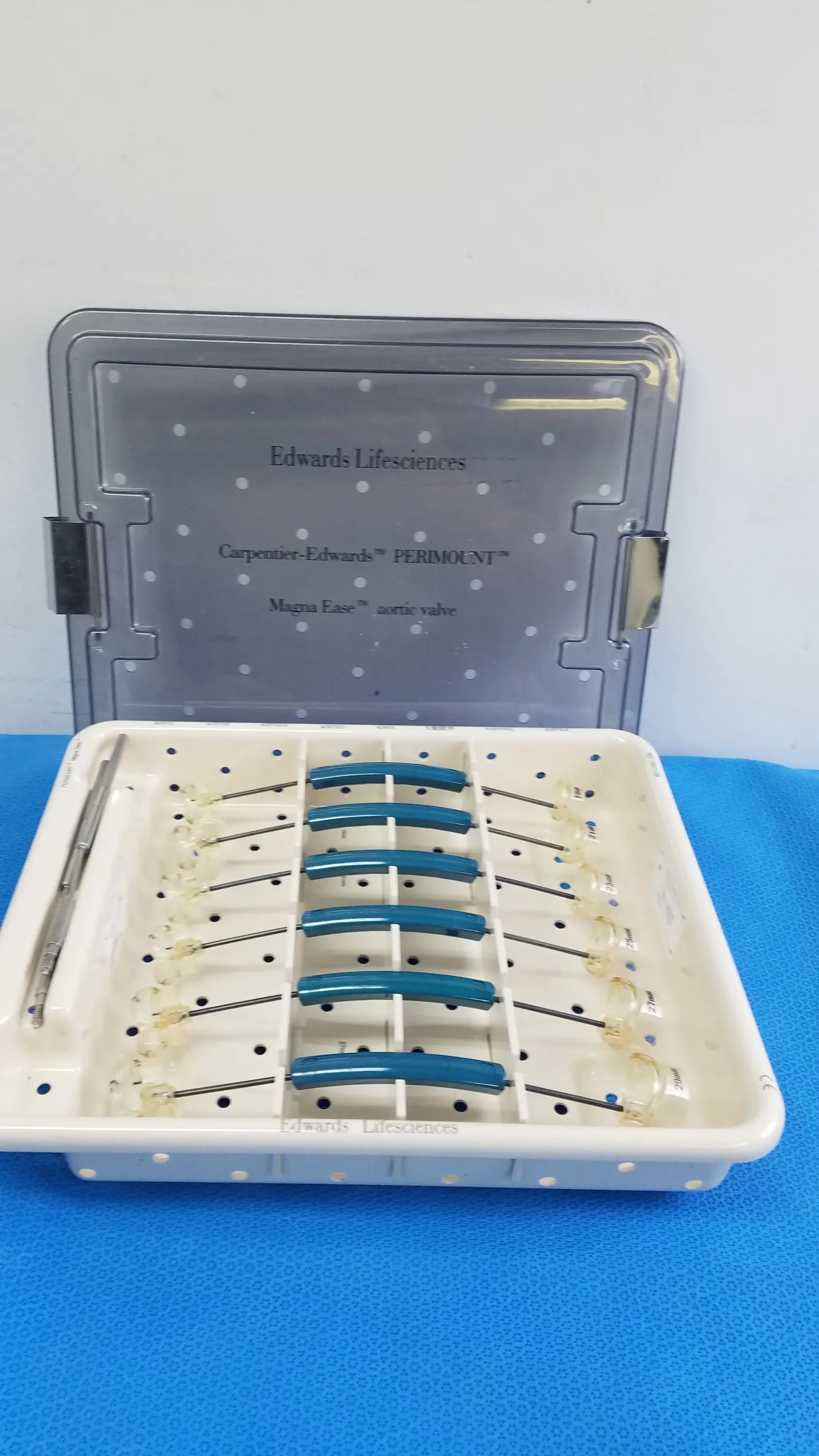 A white plastic tray with blue-tipped edwards lifesciences 1111 perimount magnas ease aortic valve sizer set pre owned medical equipment for sale