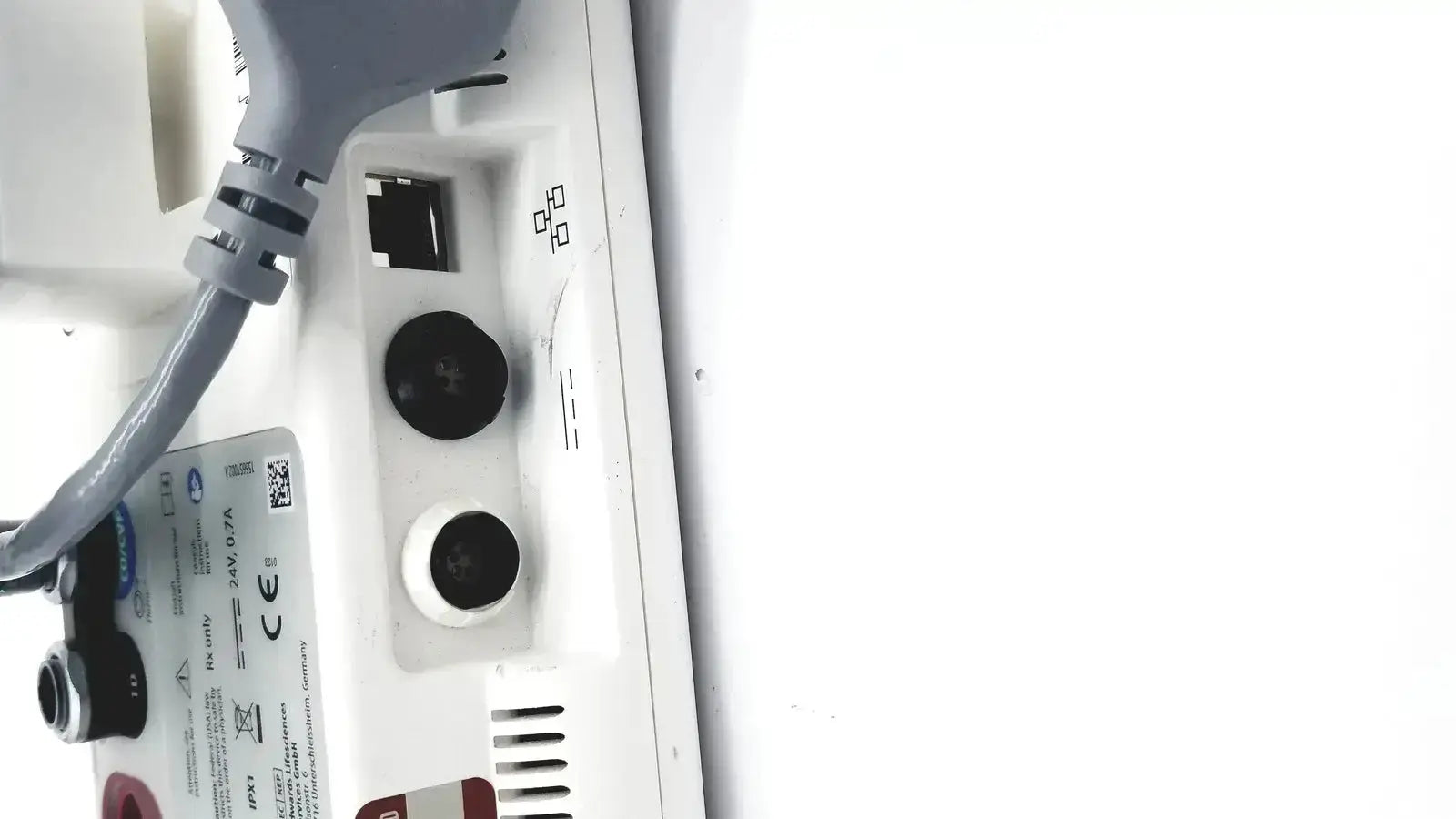 Back side of edwards lifesciences ev1000 databox with gray power cord plugged into white device with black and white circular ports