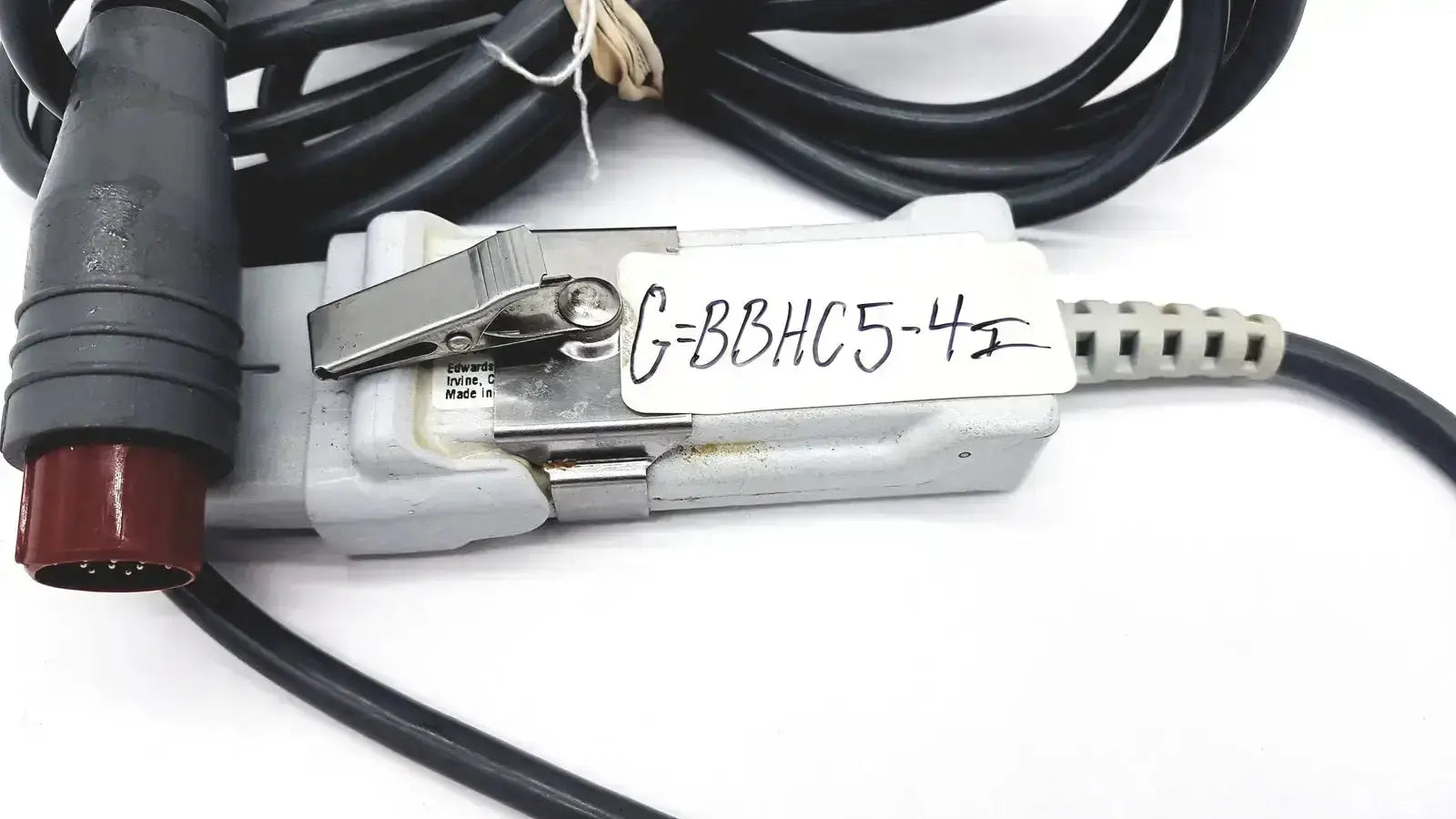Gray plastic edwards lifesciences om2 oximetry optical module cable adapter with black cables and red connector labeled g=bbhc5-4