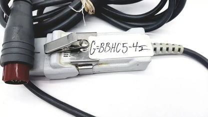 Gray plastic edwards lifesciences om2 oximetry optical module cable adapter with black cables and red connector labeled g=bbhc5-4
