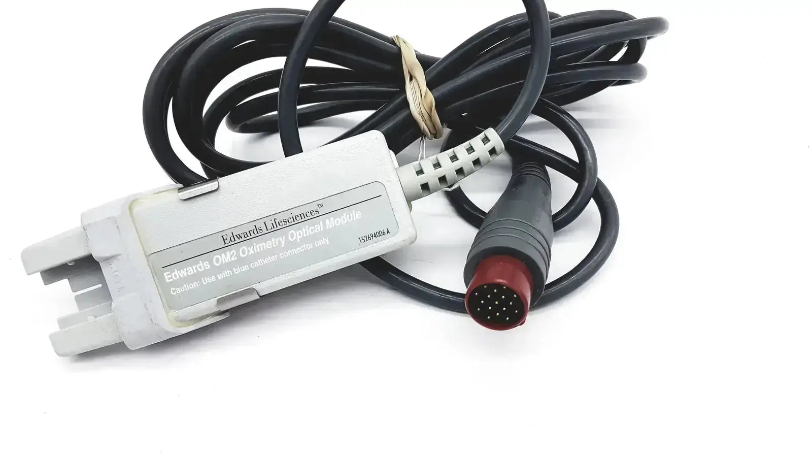 White plastic Edwards Lifesciences OM2 oximetry optical module cable with black coiled cable and red connector end