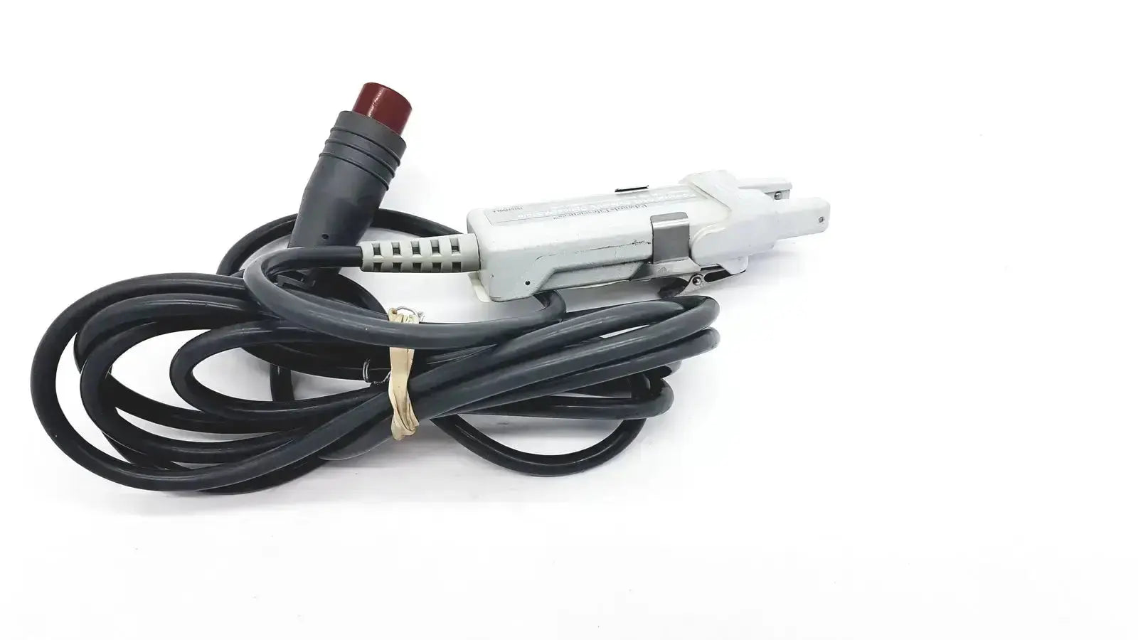 Black coiled edwards lifesciences om2 optical module cable with white plastic connector and red button end adapter