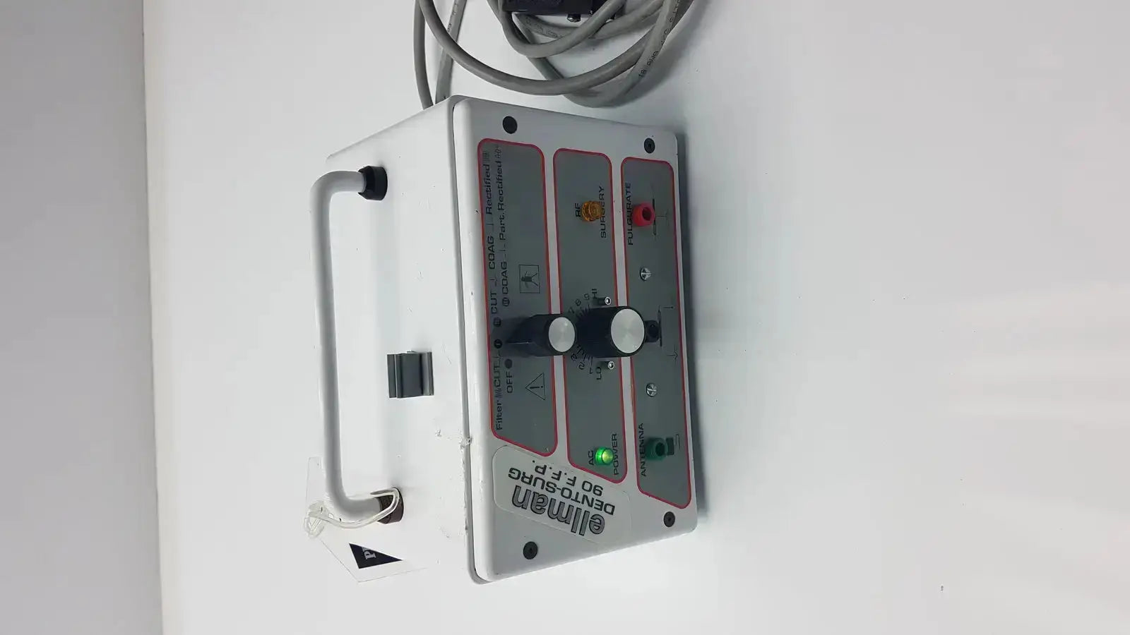 White rectangular ellman dento surg 90 ffp medical device with black handle and patient ready control panel indicators