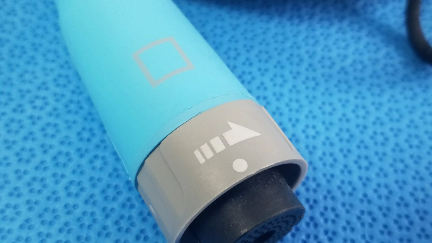 Light blue cylindrical hair dryer with gray power button and black nozzle shown with ensite x ep d-ens-l/r-cbl medical equipment catheter connector cable