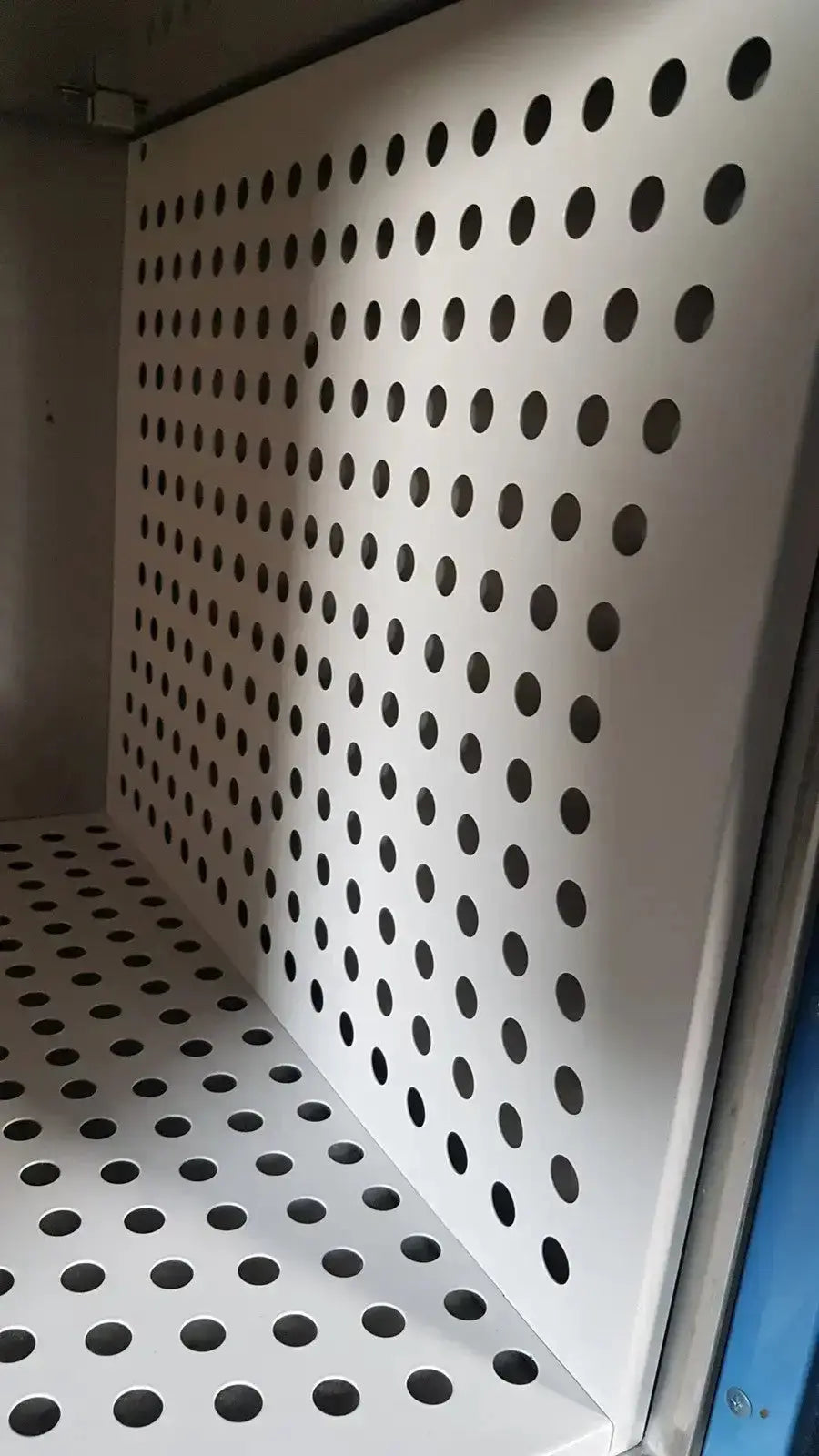White perforated metal shelf panel with circular holes for air circulation in enthermics blanket warming cabinet dc250