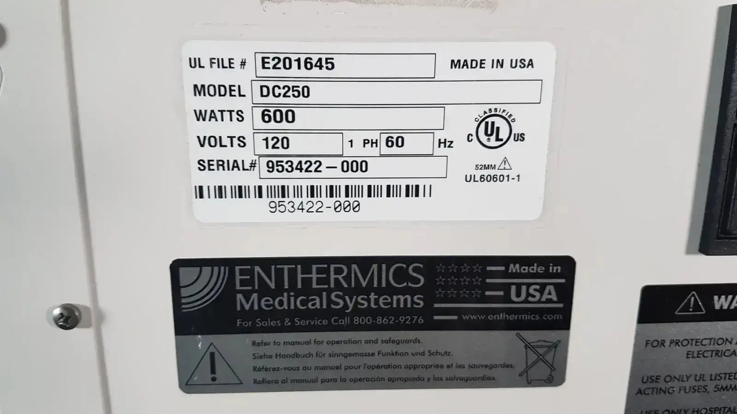 White rectangular label on the back of enthermics dc250 blanket warming cabinet showing model wattage and serial number