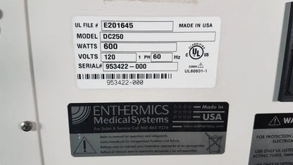 White rectangular label on the back of enthermics dc250 blanket warming cabinet showing model wattage and serial number