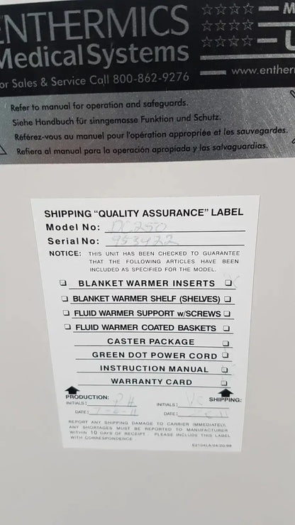 White paper label with black text and checkboxes for shipping quality assurance on enthermics blanket warming cabinet dc250