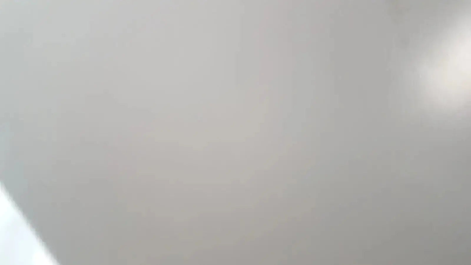 Smooth off-white ceiling of Enthermics blanket warming cabinet DC250 with soft gradient and subtle light reflection