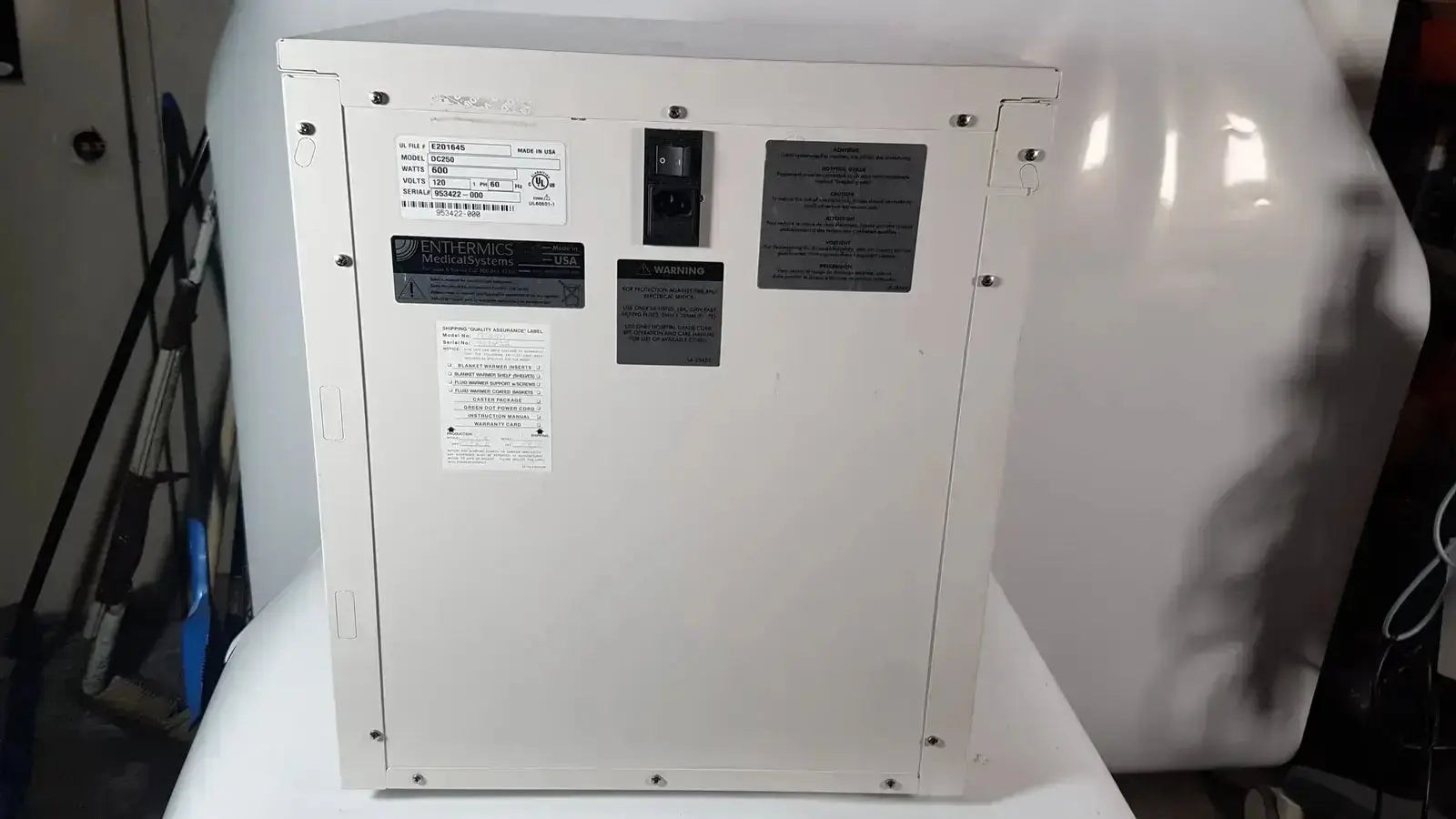White industrial-grade electrical panel with black labels and power switch on enthermics blanket warming cabinet dc250
