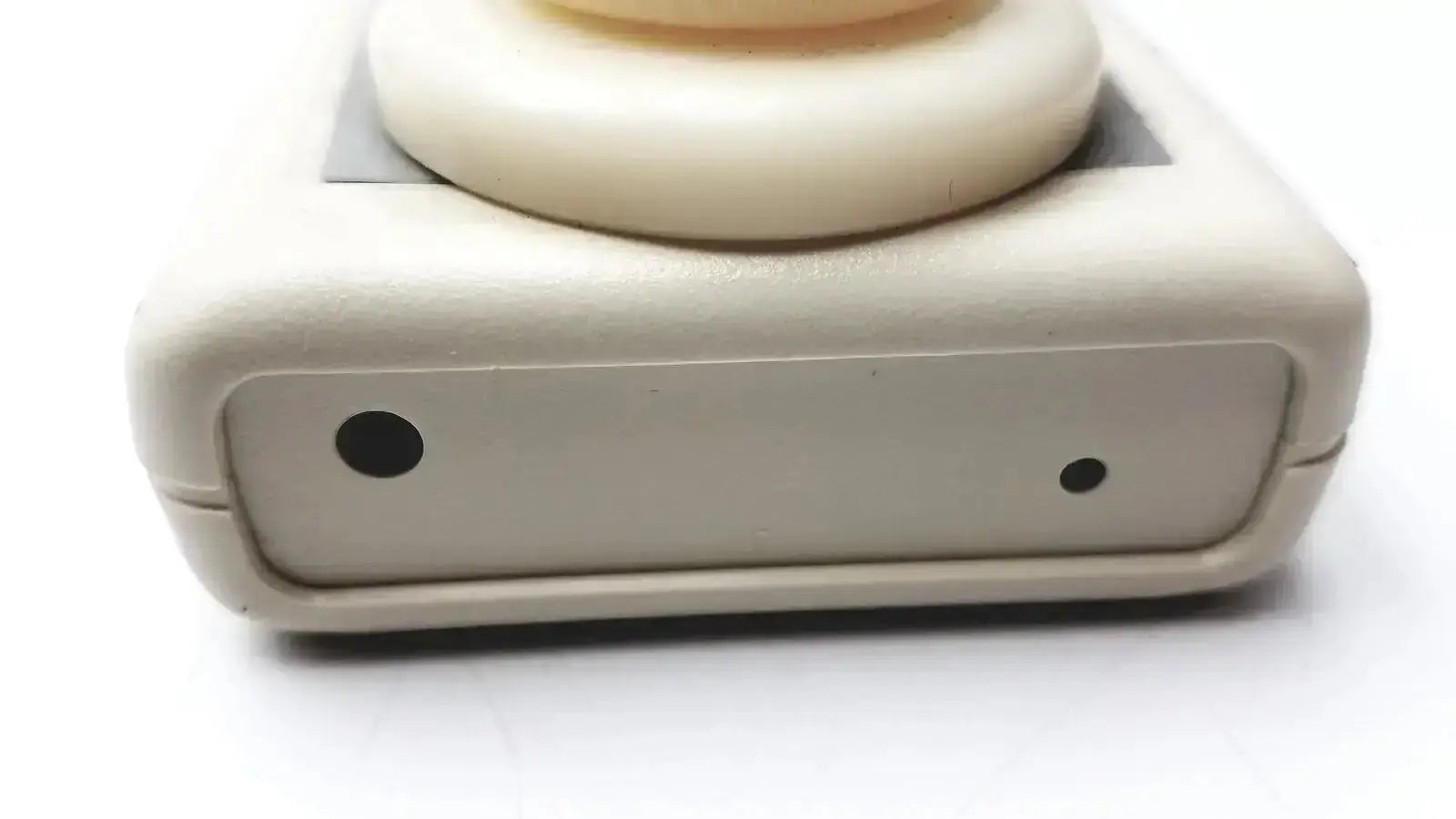 Cream-colored plastic environmental sensors z100 ethylene oxide meter with rounded top and black circular indentations