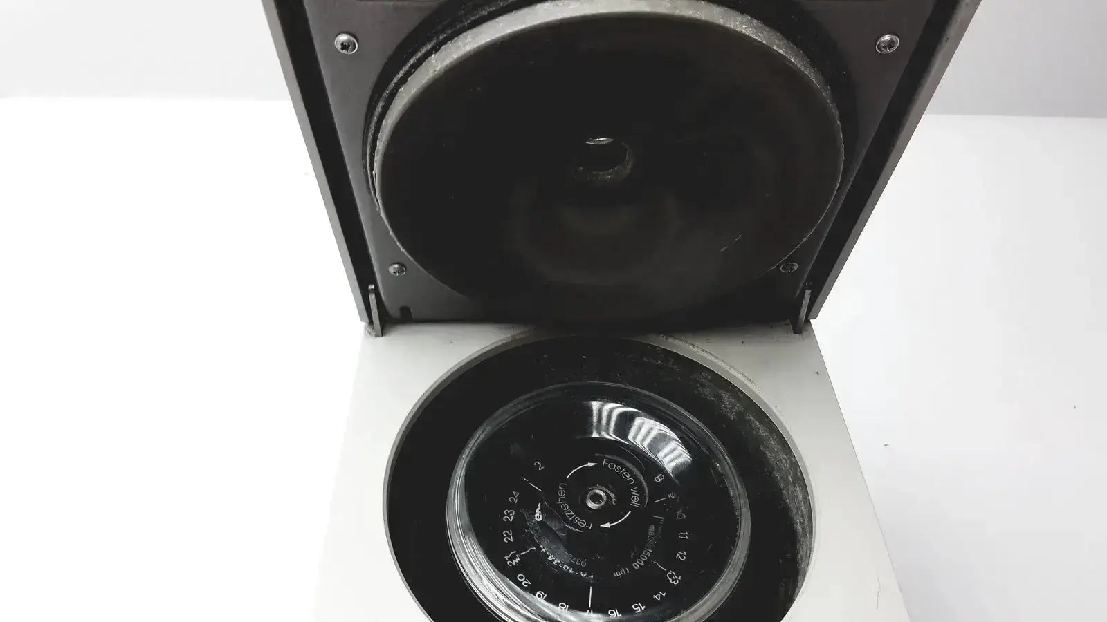 Black eppendorf 5424 centrifuge with circular rotor chamber and numerical lid markings available as pre owned medical equipment