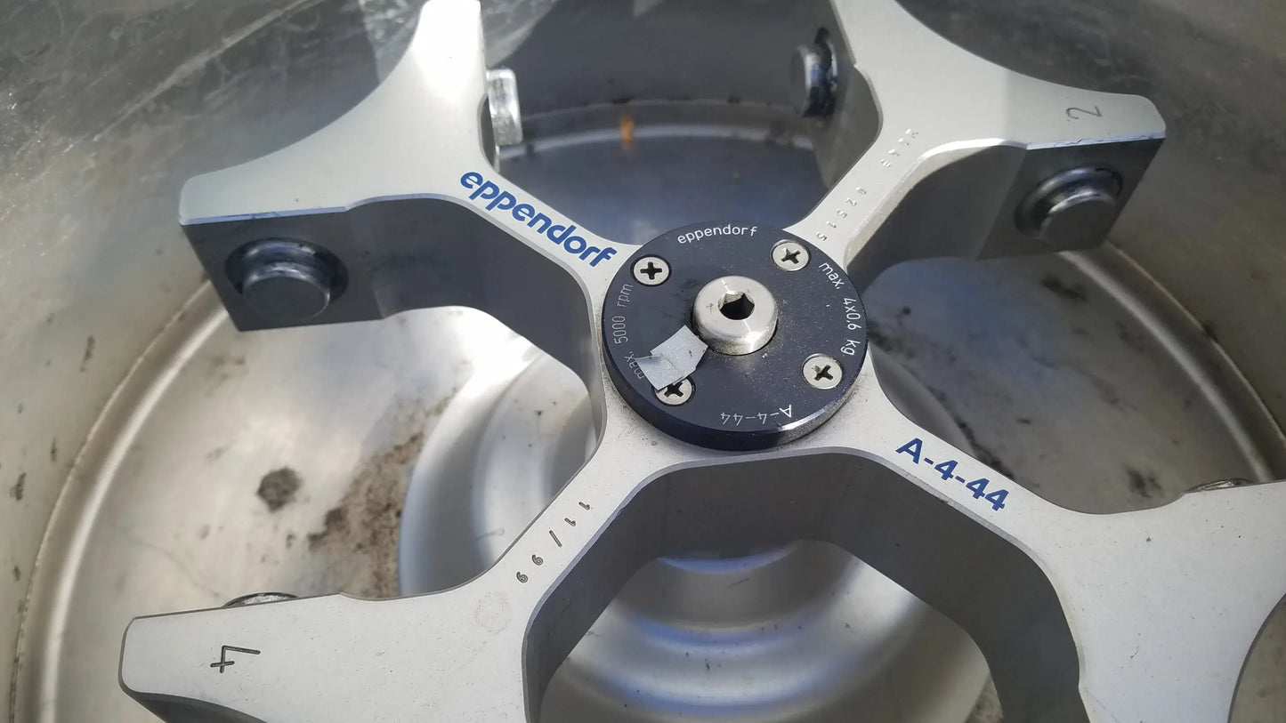 Silver metallic rotor with black central hub and blue eppendorf a-4-44 branding for eppendorf 5804 refrigerated benchtop centrifuge used medical equipment for sale