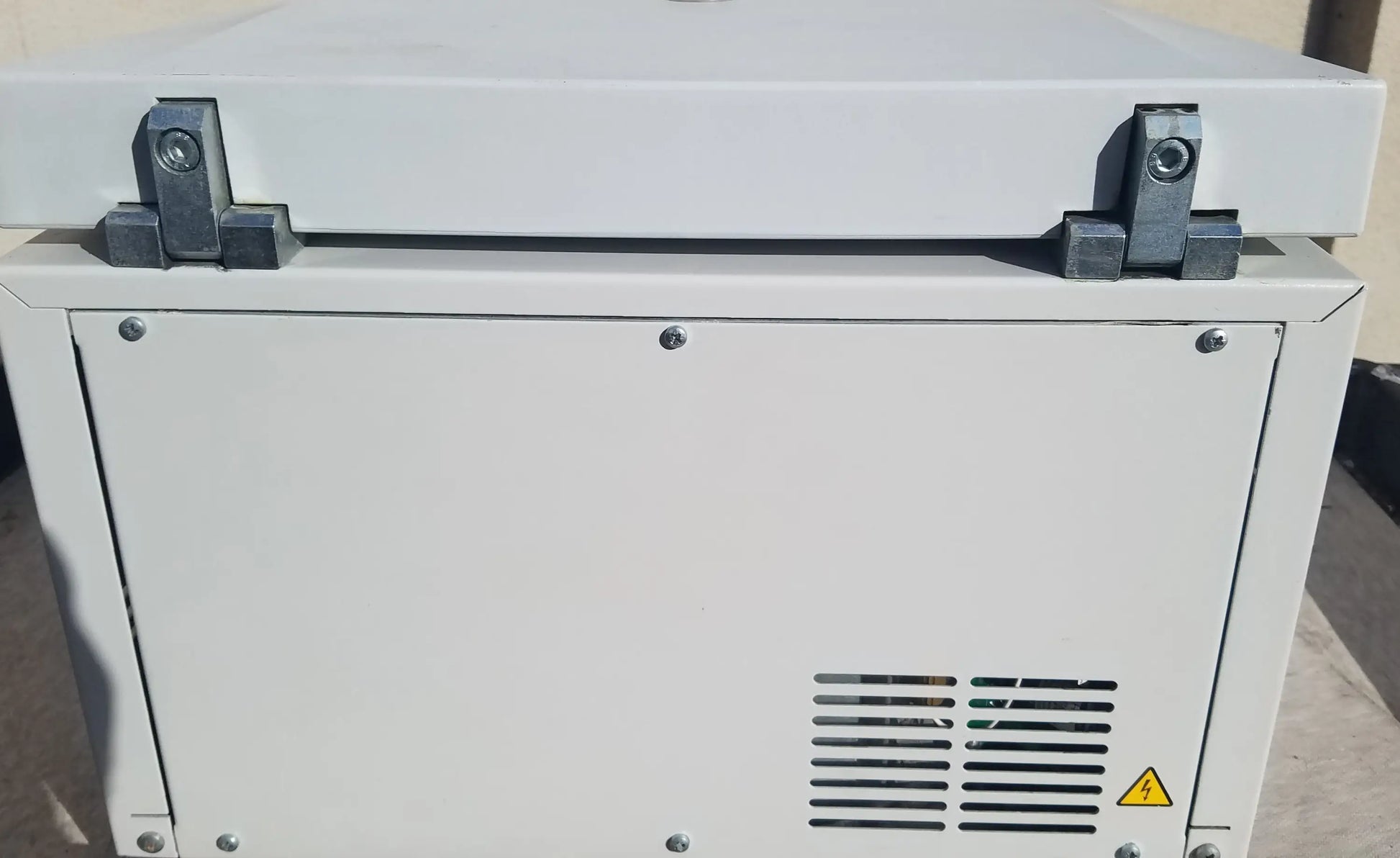 White industrial generator with metallic latches and vented panel on the back of eppendorf 5804 refrigerated benchtop centrifuge for buy used medical equipment