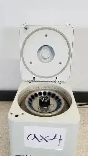 Beige eppendorf centrifuge 5415c with white lid circular rotor chamber and handwritten label a x 4 on front panel