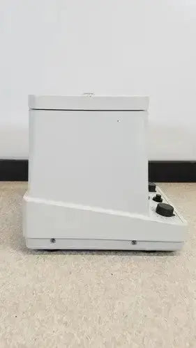 White plastic eppendorf centrifuge 5415c with black control knobs on the side for precise laboratory use