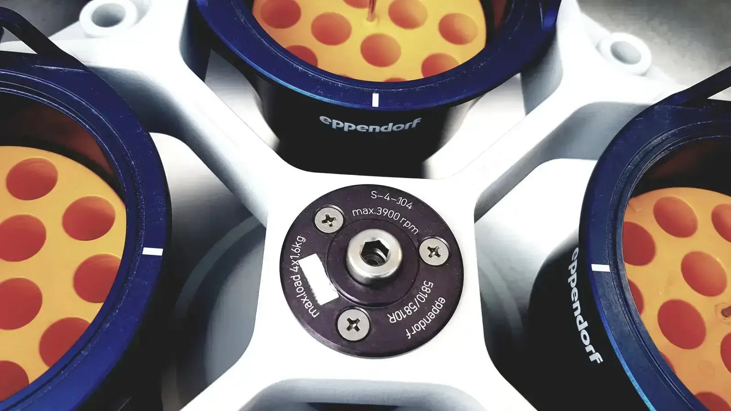 Image of eppendorf centrifuge 5810 rotor with blue and black components and orange wells with red dots for biomedical technicians