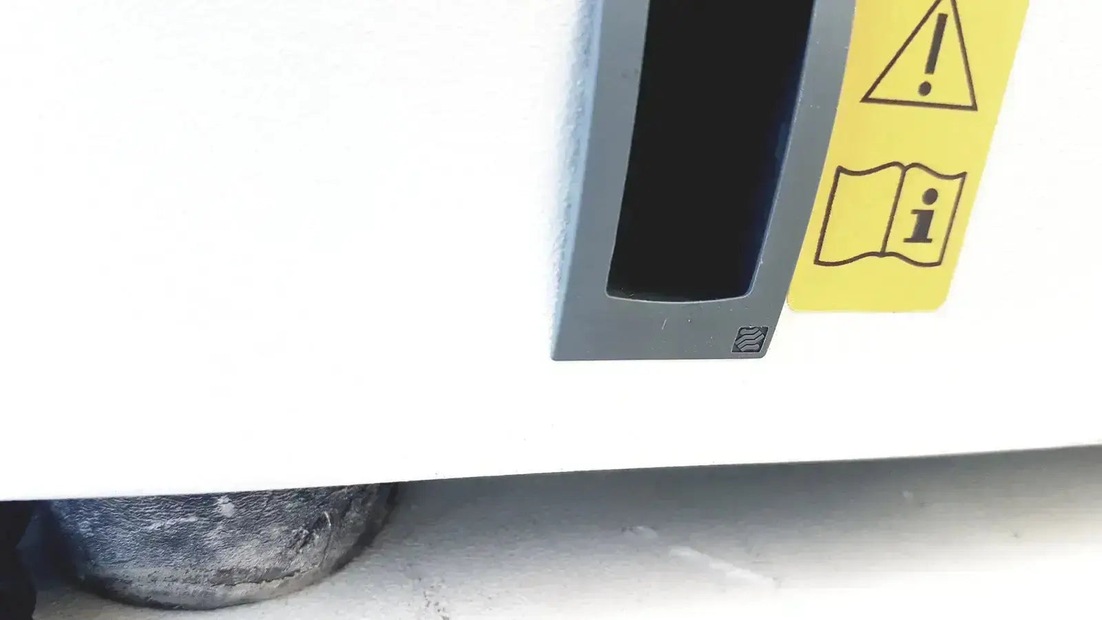 Gray plastic slot with yellow warning label on the back of eppendorf centrifuge 5810 for biomedical technicians