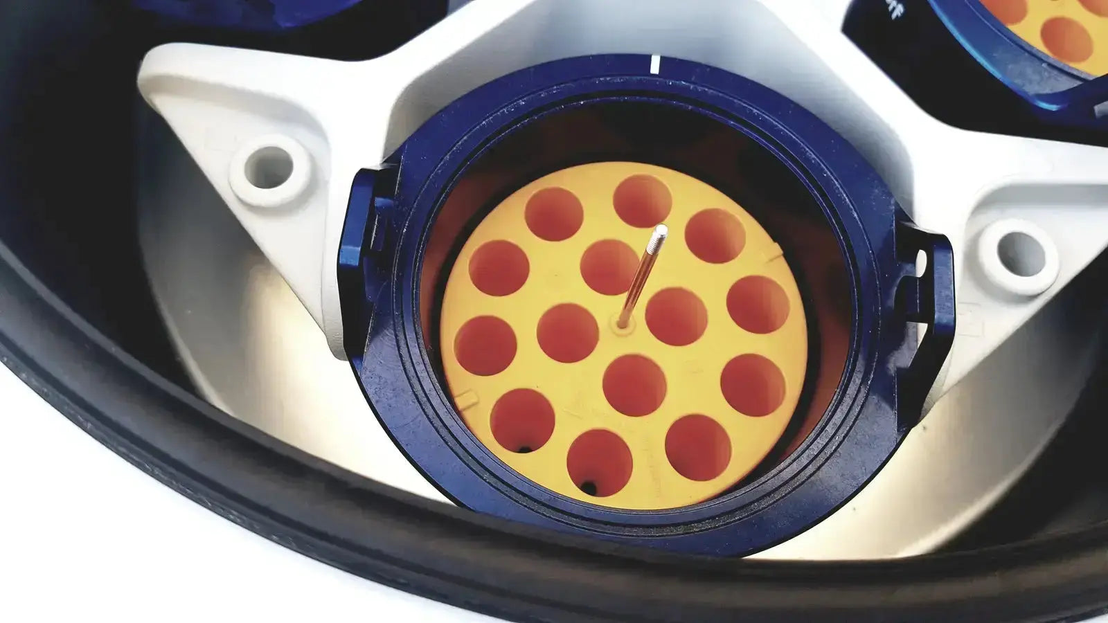 Blue and yellow circular rotor with red dot grid in eppendorf centrifuge 5810 used by biomedical technicians from hospital surplus