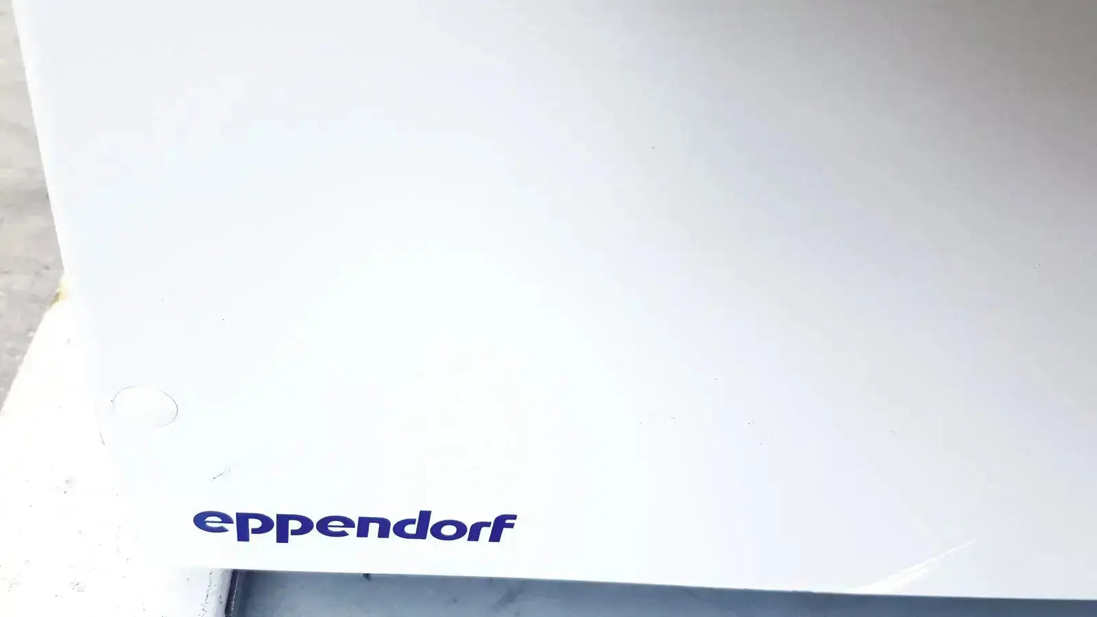 White eppendorf centrifuge 5810 container with minimalist design in dark blue print for biomedical technicians and hospital surplus