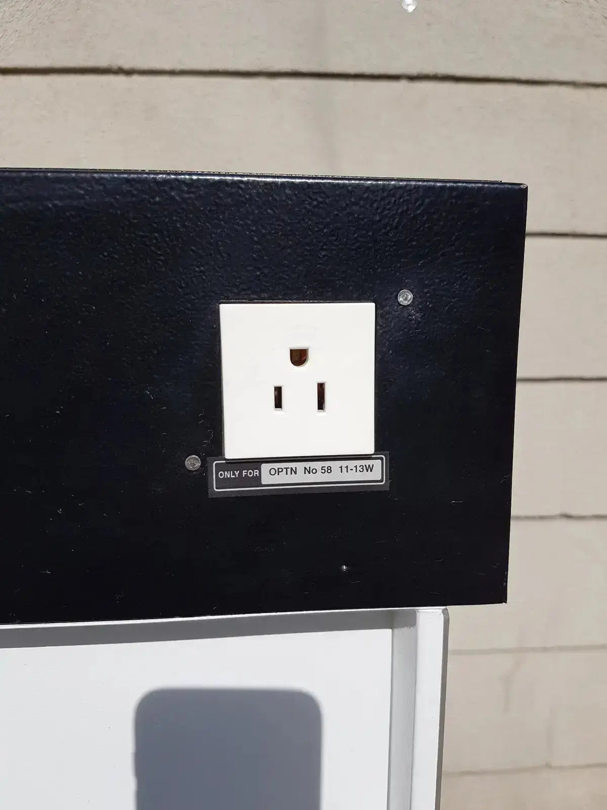 White electrical outlet mounted on black panel at the back of erlab captair bio chem filtair ductless filtering fume enclosure