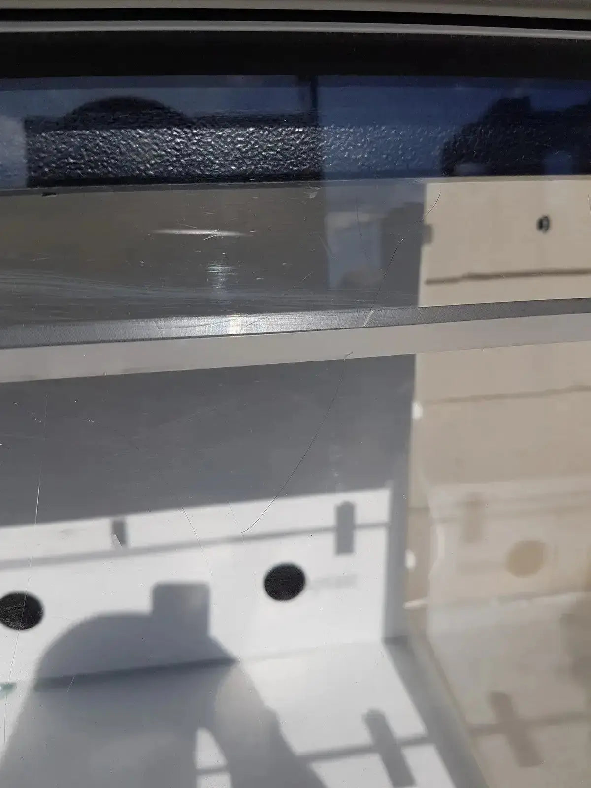 A sleek transparent acrylic shelf with polished silver metallic edge in erlab captair bio chem filtair fume enclosure