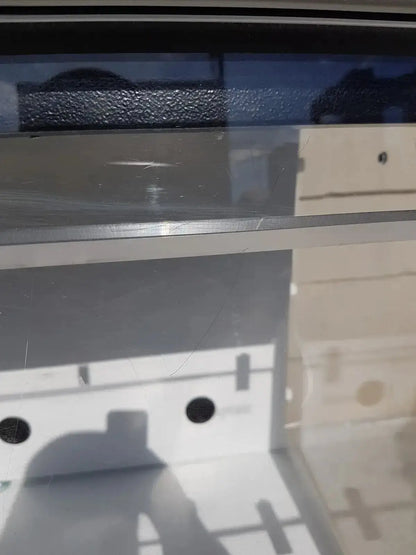 A sleek transparent acrylic shelf with polished silver metallic edge in erlab captair bio chem filtair fume enclosure