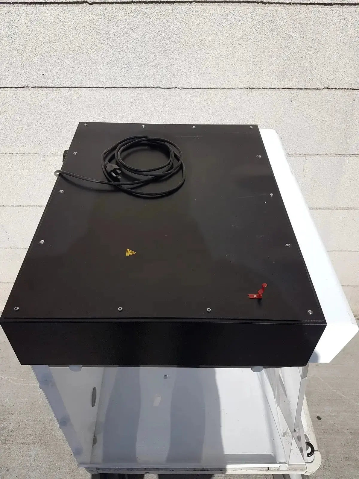 Black rectangular erlab captair bio chem filtair ductless filtering fume enclosure with coiled cable and warning triangle on top