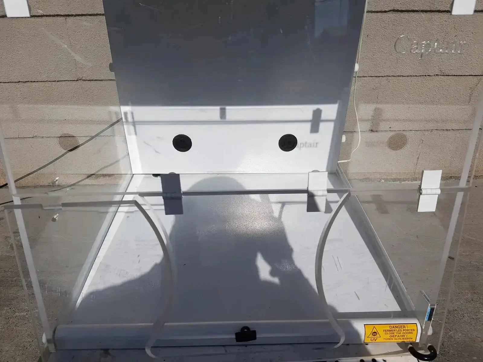 Clear acrylic safety enclosure with white interior and gray metal frame featuring circular cutouts for erlab captair bio chem filtair hood