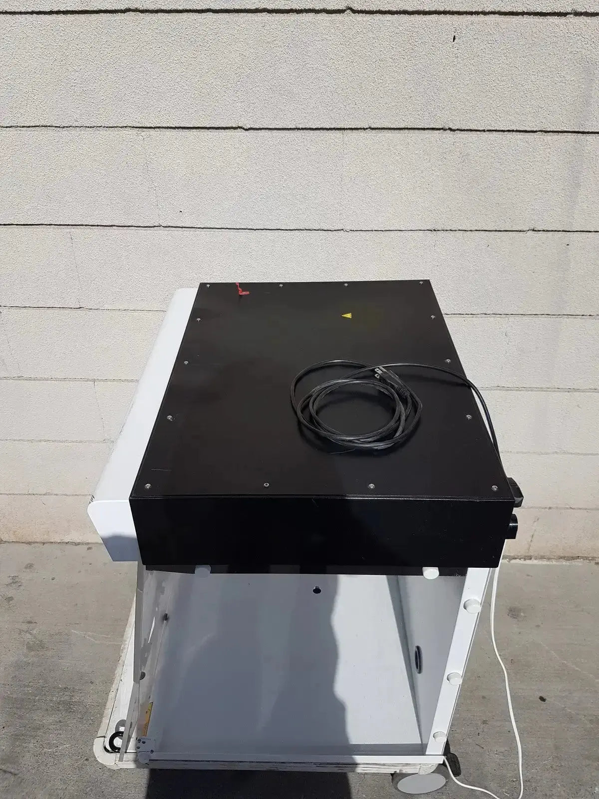 Black and white industrial-grade scanner with coiled cable on top for erlab captair bio chem filtair ductless filtering hood