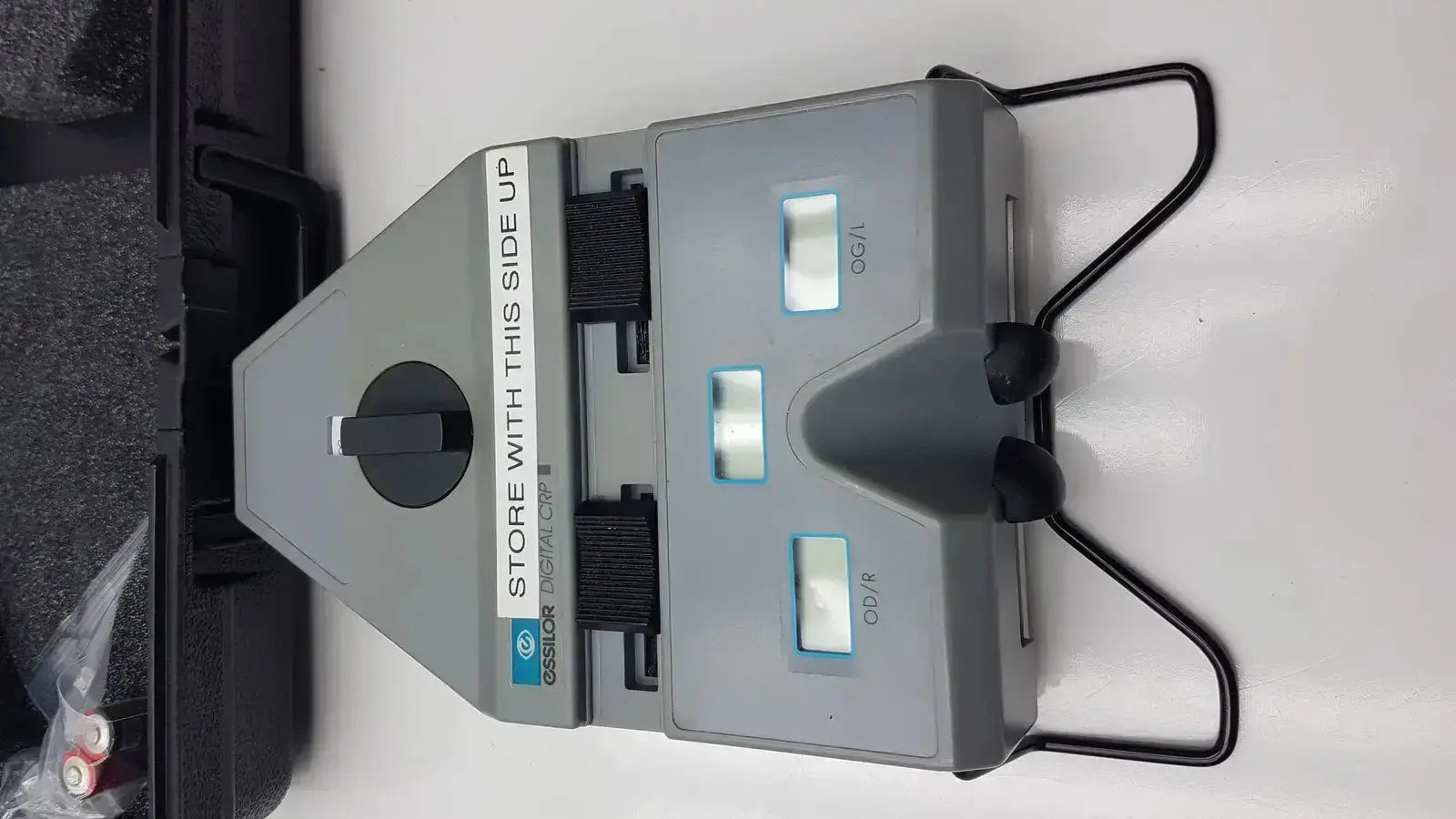 Gray plastic Essilor X81701 precision digital crp corneal reflection pupilometer with black handles and three illuminated displays