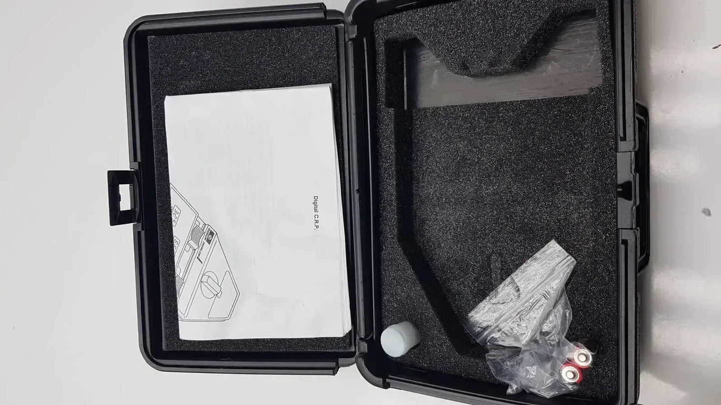 Black hard-shell case with molded foam interior holding essilor x81701 precision digital crp pupilometer components and manual