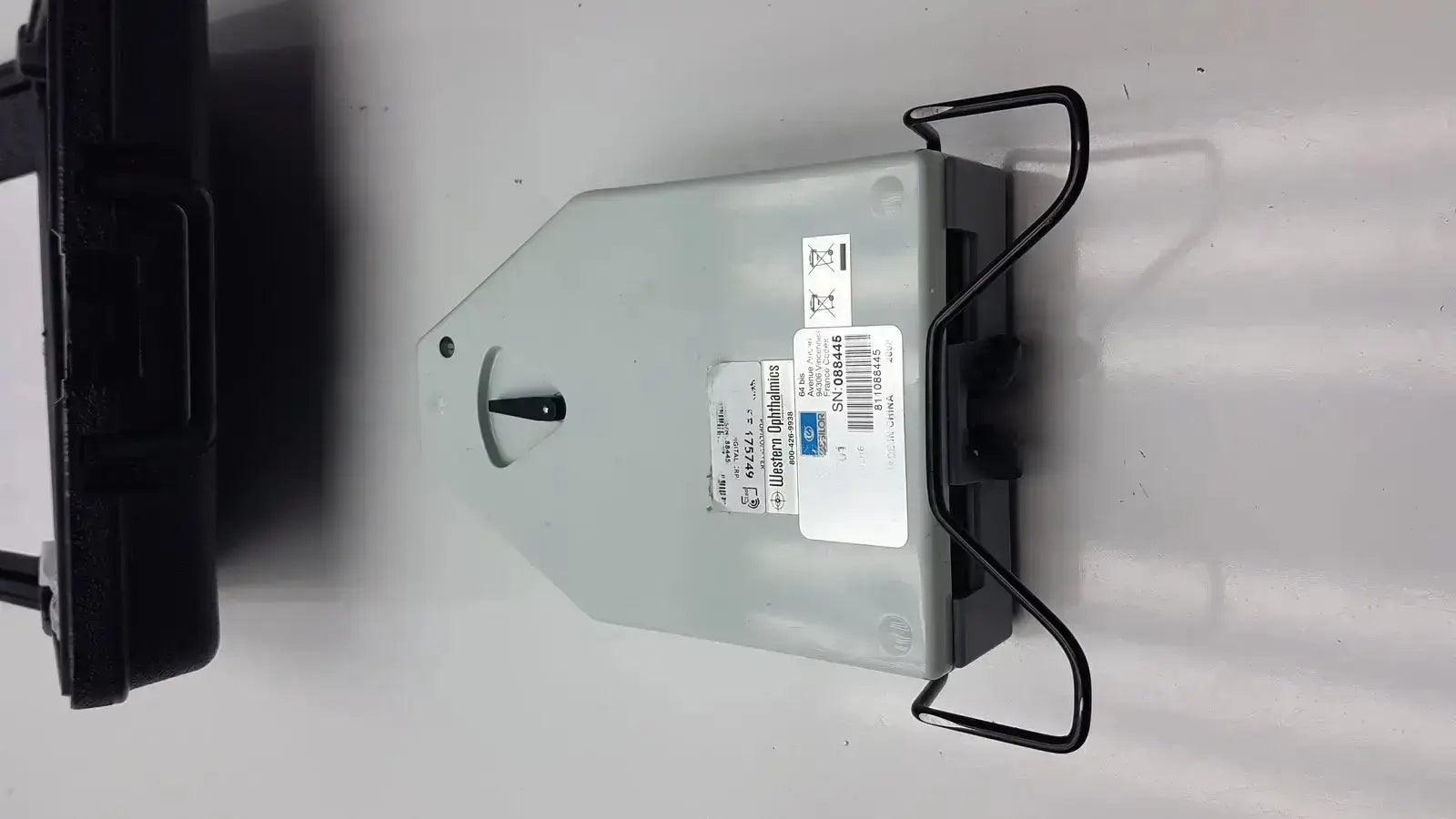 Gray metallic electrical meter with black wire hanger and white label for essilor x81701 precision digital crp pupilometer