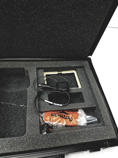 Orange biohazard eutechninc precision temperature 4500 thermo meter wrapped in plastic in black foam case with cables