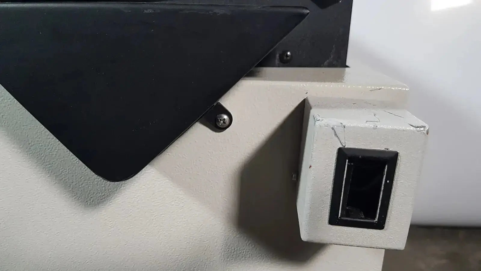 Black rectangular slot on weathered off-white industrial control box of excellent spex 6850 freezer mill for biomedical evaluation of hospital surplus