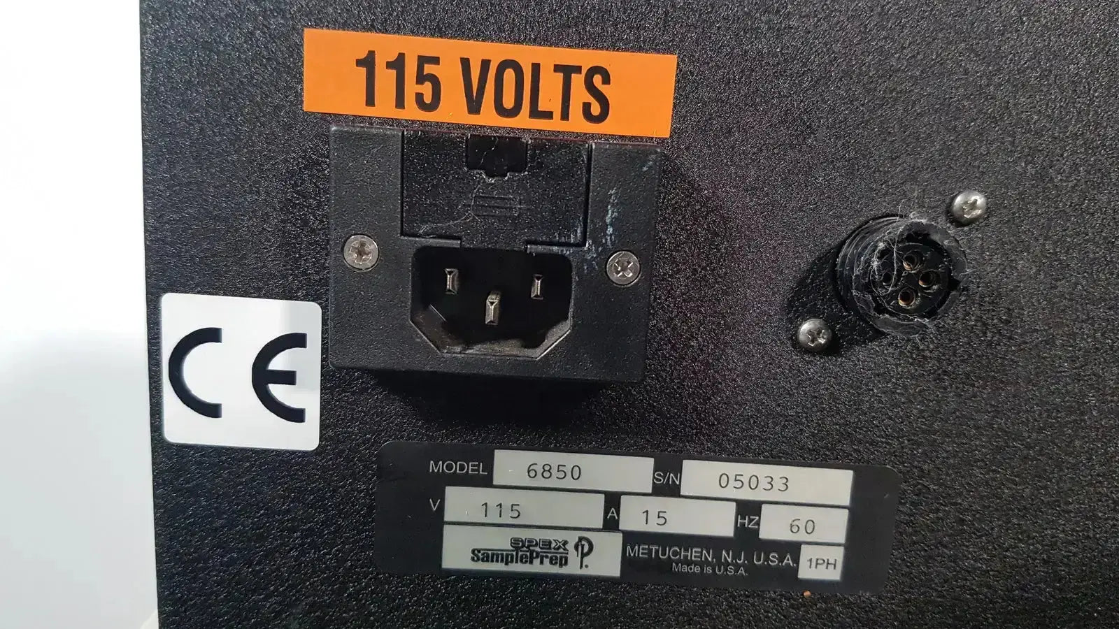 Back side of excellent spex 6850 freezer mill power input panel with orange 115 volts label for biomedical evaluation