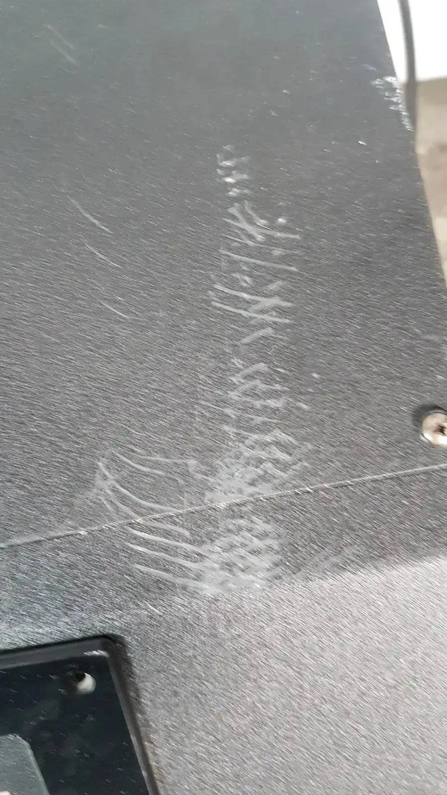 Black textured back surface with white scuff marks and metal screw on excellent spex 6850 freezer mill for biomedical evaluation