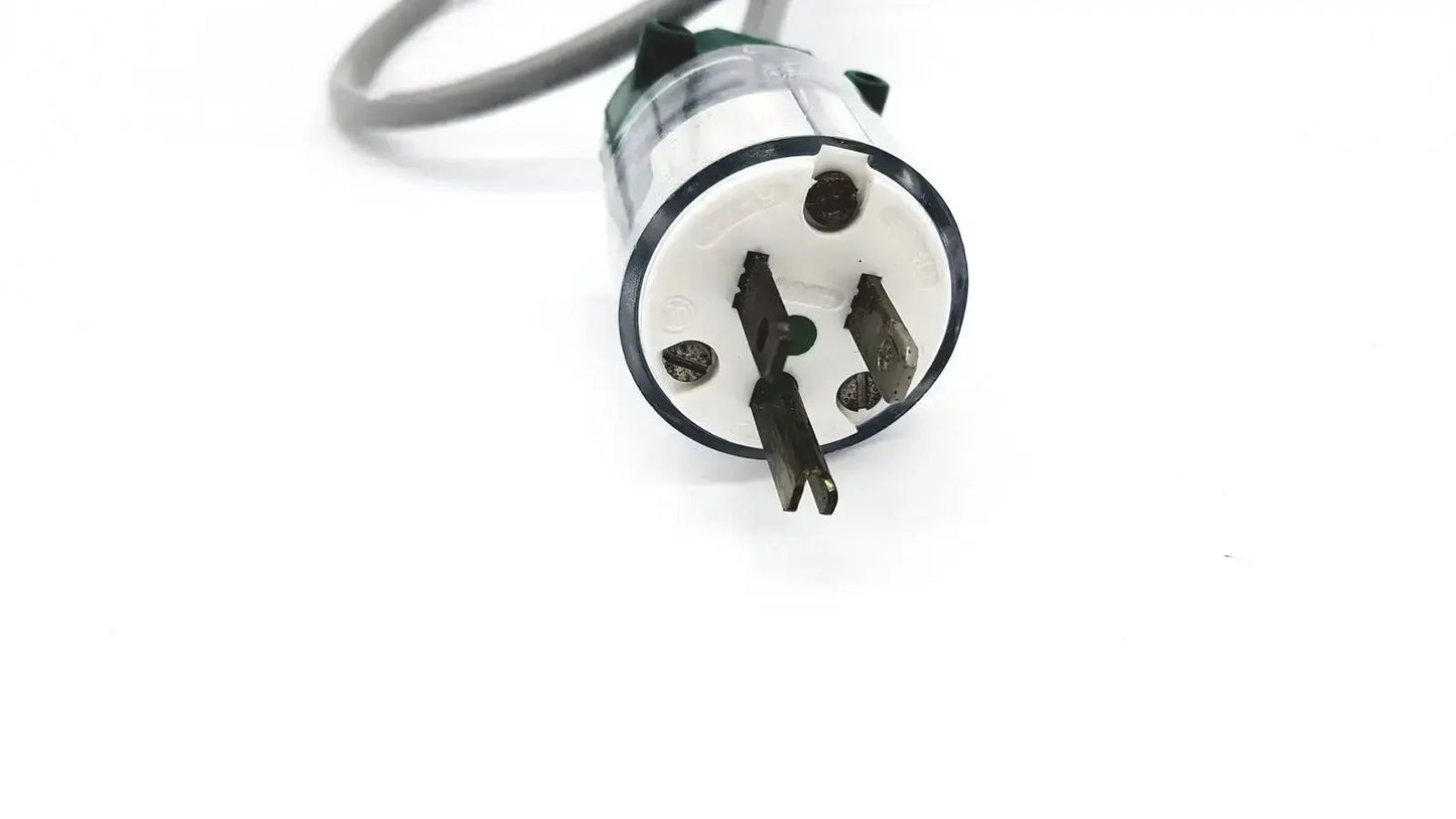 Black and white three-prong electrical plug on grey AC power cable exito exp-005 grey for reliable power connection