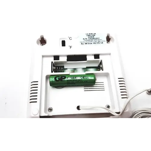 Green gp greencell battery nestled in a white plastic compartment.